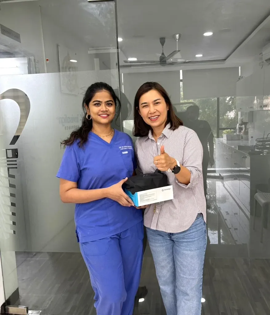 Dr. R. Sivaranjani with a patient holding an Invisalign box at Luxe Dental Clinic, Velachery