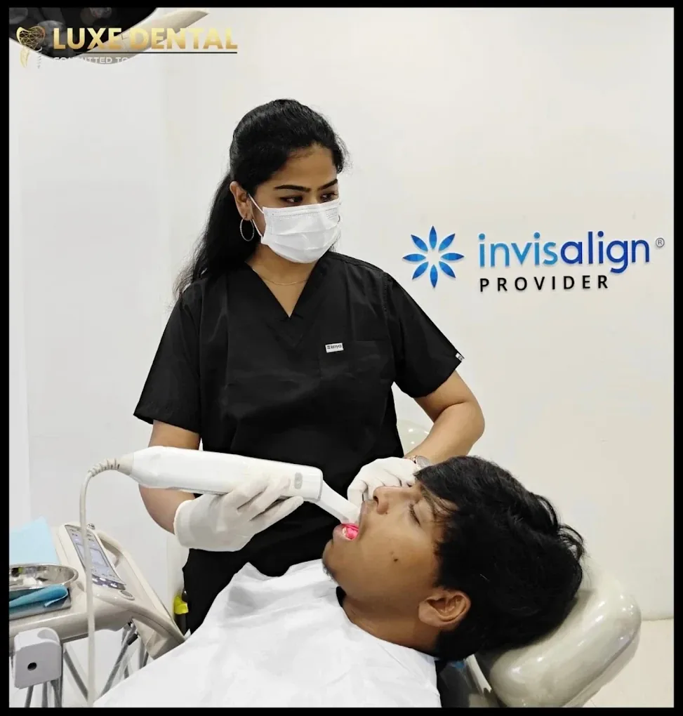 Patient having a digital iTero scan in front of the Invisalign Provider sign at Luxe Dental Clinic, Velachery